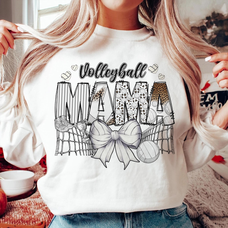 a woman wearing a white volleyball mama shirt