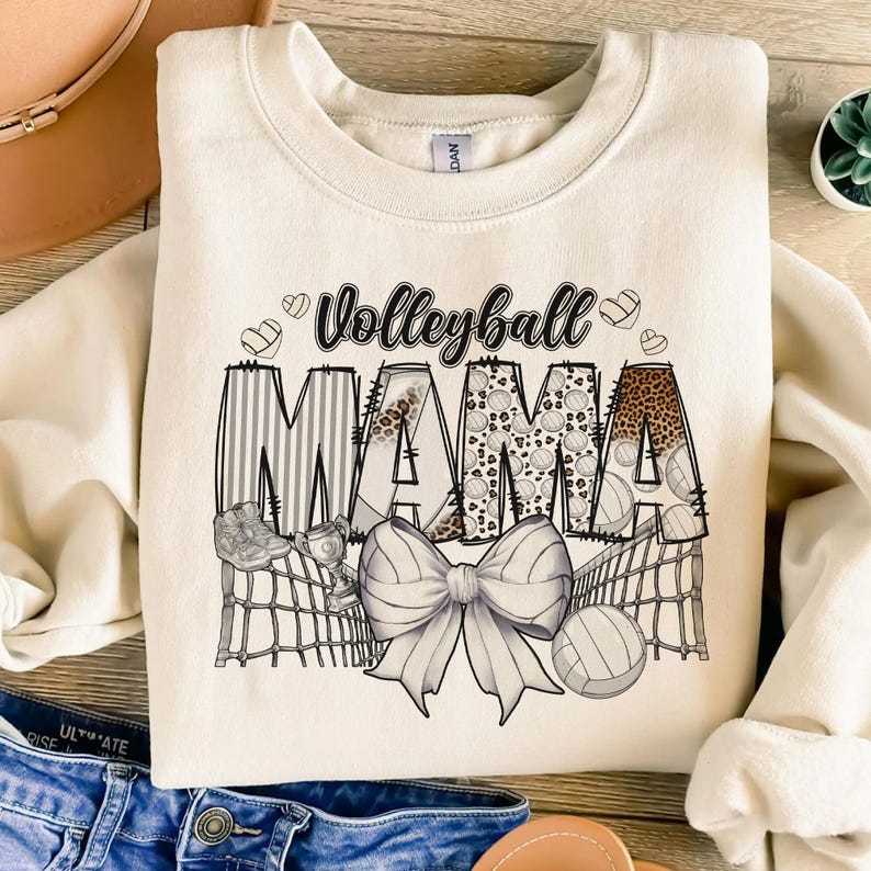 a t - shirt that says volleyball mama with a bow