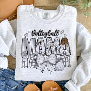 a shirt that says volleyball mama with a bow on it