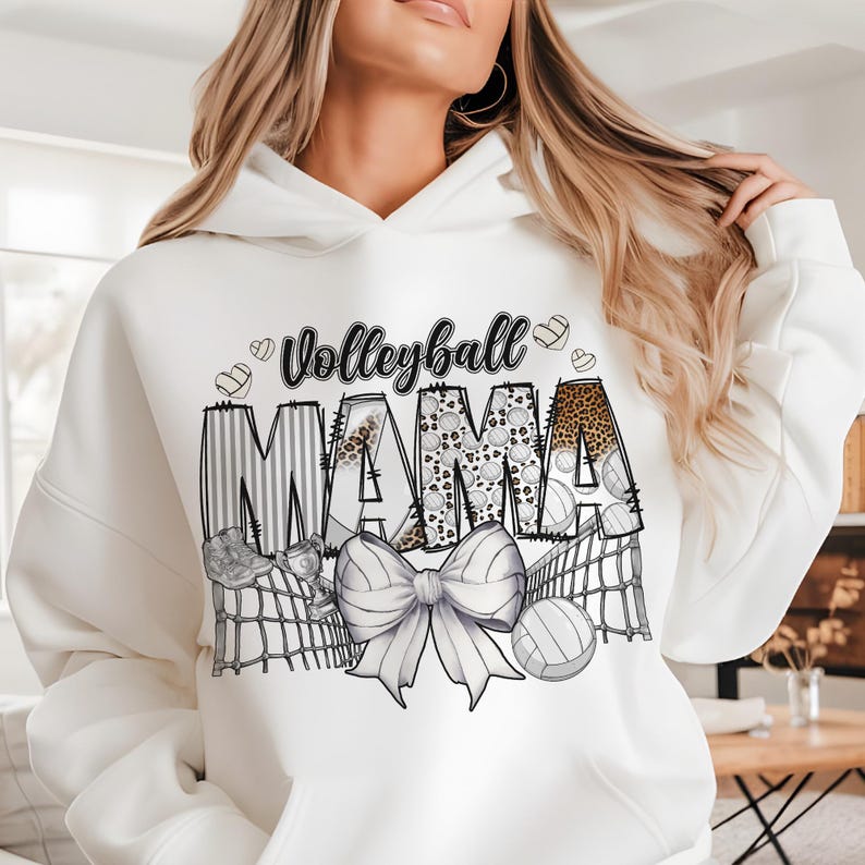 a woman wearing a white hoodie with the words, volleyball mama on it