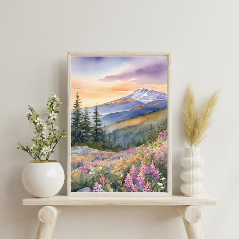 May include: Watercolor painting of a mountain range with a snow-capped peak in the distance. The foreground features a field of purple and pink wildflowers.