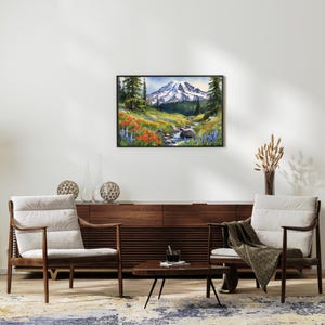 May include: A framed watercolor painting of a mountain scene with a stream running through a field of wildflowers. The mountain is snow-capped and the sky is blue. The painting is framed in black.