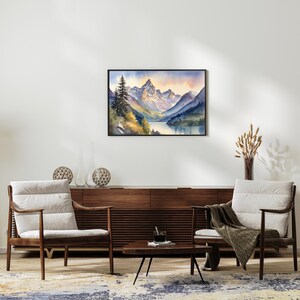 May include: Watercolor painting of a mountain range with a lake in the foreground. The mountains are a light blue and purple color, and the lake is a dark blue. There are trees on the left side of the painting, and the sky is a light pink and orange color.