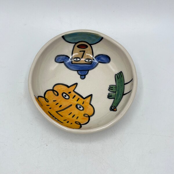 Hand painted shallow 4 1/2"ceramic bowl- yellow cat, person, bird