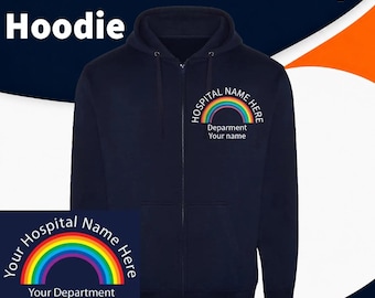 May include: A navy blue full-zip hoodie featuring a rainbow graphic on the left chest. The text reads Hospital Name Here, Department, and Your Name. A separate square inset shows the same rainbow design with the text Your Hospital Name Here and Your Department Staff Name.
