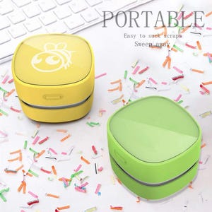 May include: A white ceramic mug with a black handle and the text "But First, Coffee" in a black, handwritten-style font. The mug is on a white surface.