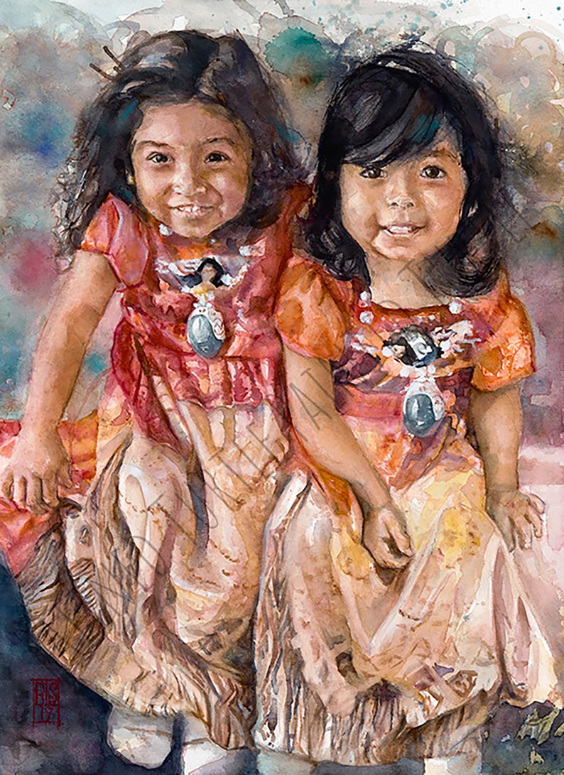 May include: Two young girls wearing traditional Native American clothing with intricate beadwork and turquoise accents. They are smiling and sitting together, with the girl in the front holding a small object in her hand.