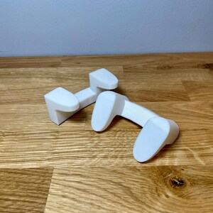 front view of the pan lid holder / mount on a wooden desk with grey background