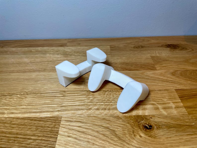 front view of the pan lid holder / mount on a wooden desk with grey background