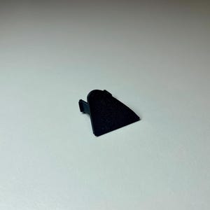 Black triangle cover plate shown on a white background