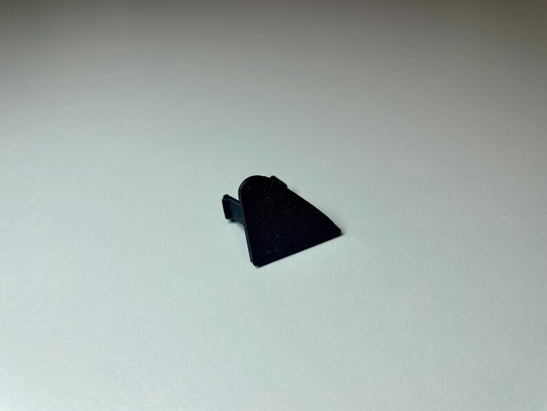 Black triangle cover plate shown on a white background