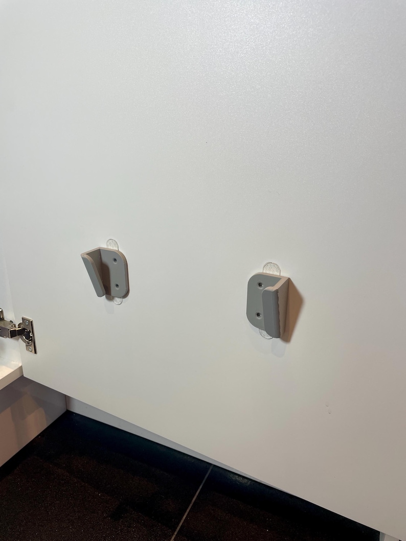grey mounts on the inside of a kitchen cabinet door