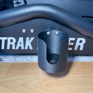 Cup holder for the trak racer TR8 in black installed on a sim rig