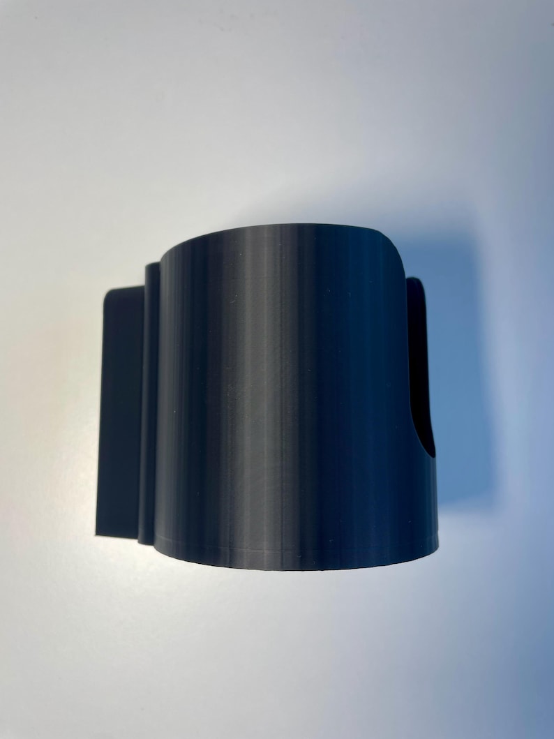 Cup holder for the trak racer TR8 in black on a white desk