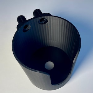 Cup holder for the trak racer TR8 in black on a white desk