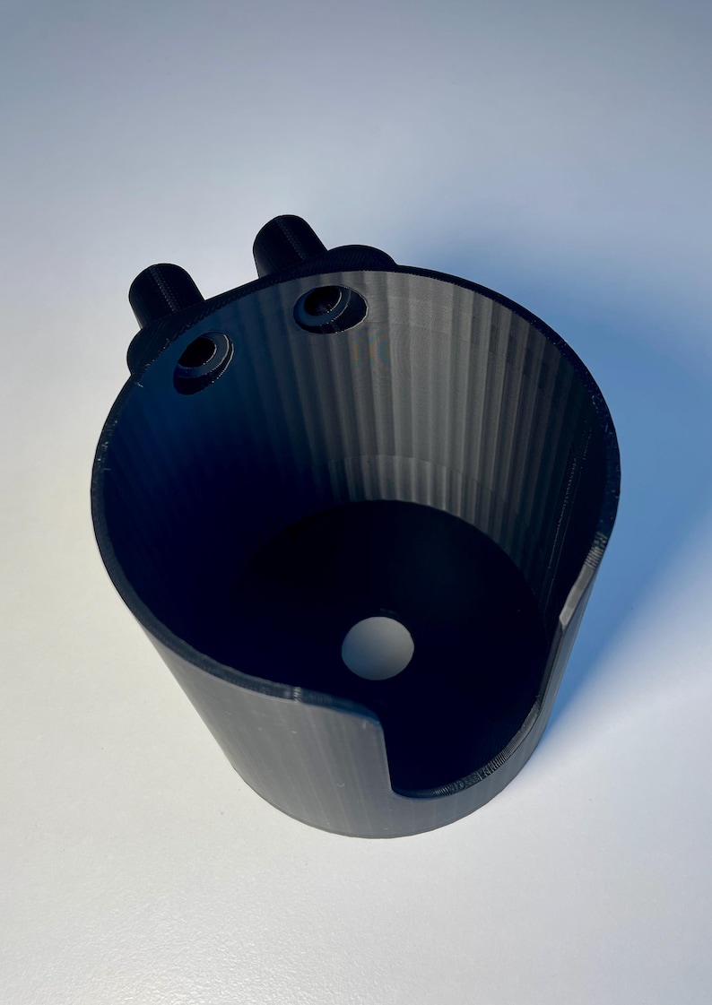 Cup holder for the trak racer TR8 in black on a white desk