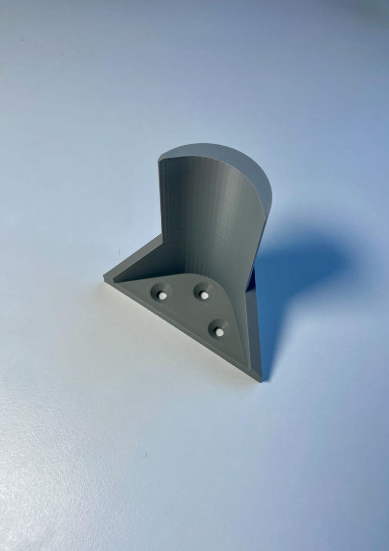 May include: A gray 3D printed corner shelf bracket with four screw holes.