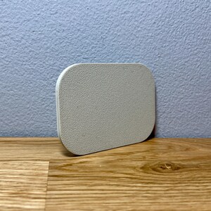 May include: A white, round, textured coaster. The coaster is made of a soft, absorbent material and is perfect for protecting surfaces from spills and scratches.