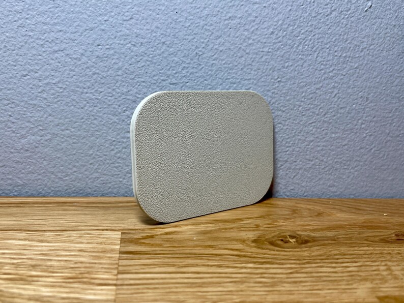 May include: A white, round, textured coaster. The coaster is made of a soft, absorbent material and is perfect for protecting surfaces from spills and scratches.