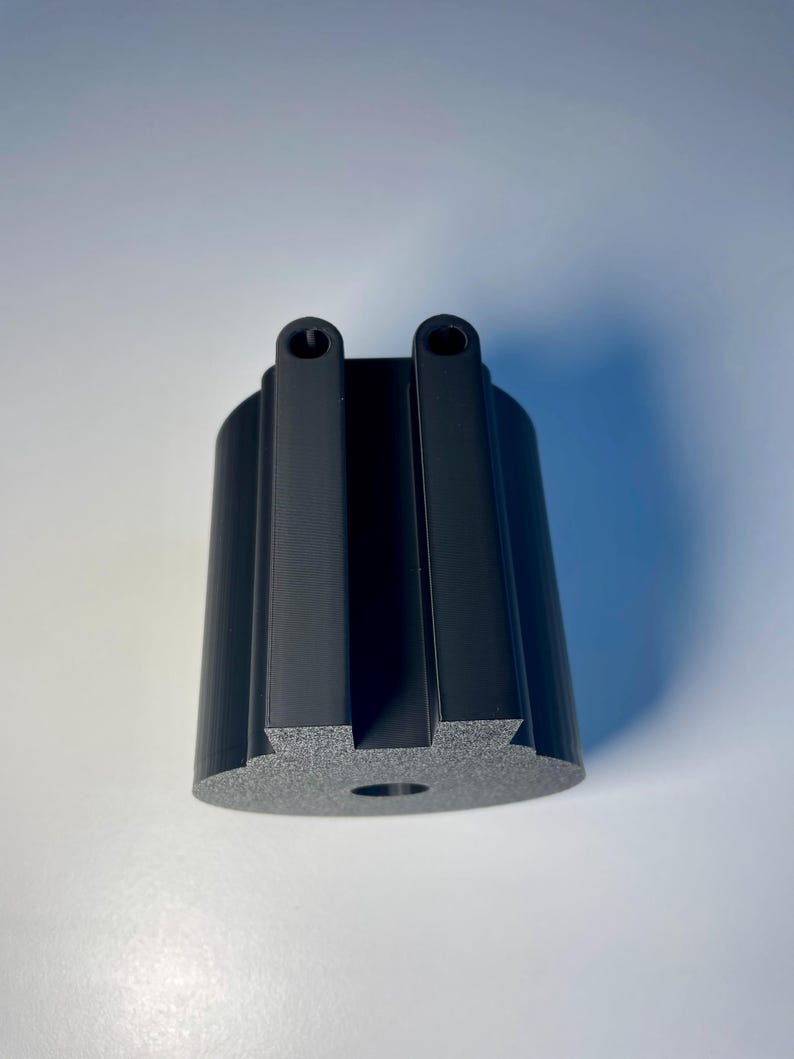 Cup holder for the trak racer TR8 in black on a white desk