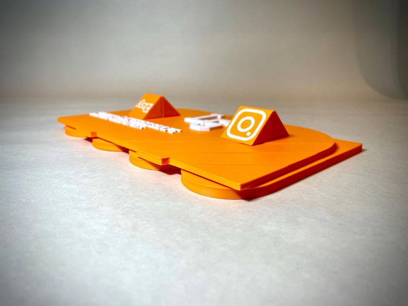 May include: Bright orange platform with two triangular accents, one with the Etsy logo and the other with the Instagram logo. The platform has a layered design with rounded edges and white text.