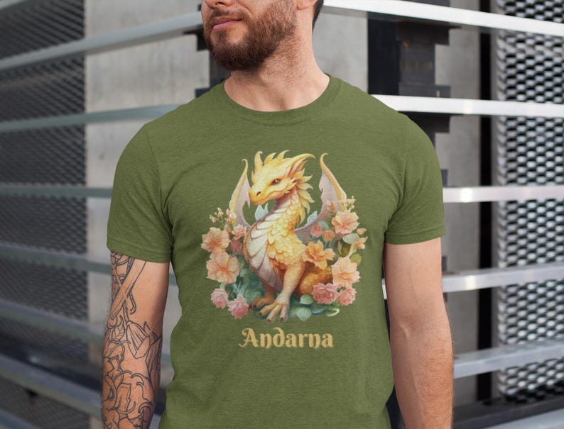 May include: A green t-shirt with a yellow dragon surrounded by pink and white flowers. The text "Andarna" is printed below the dragon.