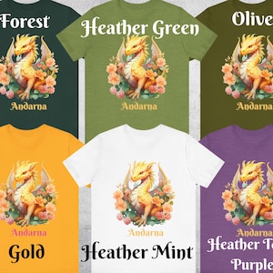 May include: A set of ten t-shirts featuring a yellow dragon with floral accents. The t-shirts are available in ten different colors: forest, olive, heather green, gold, heather mint, and heather team purple.
