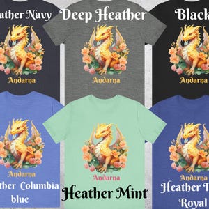 May include: A mockup of a t-shirt featuring a yellow dragon with pink flowers and the text "Andarna" in a black font. The t-shirt is shown in 10 different colors: Heather Navy, Deep Heather, Black, Heather Columbia Blue, Heather Mint, Heather True Royal.