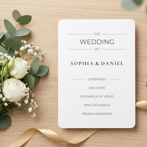 May include: A white wedding program with the text "The Wedding of Sophia & Daniel" and ceremony details. A bouquet of white roses and greenery with a gold ribbon is on the left. A gold wax seal is on the right.