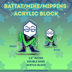 May include: A double-sided acrylic block featuring a cartoon character with a white head, green eyes, and a black and green outfit. The block is 2.5 inches and has the text "BATTAT/MIKE/MIPPINS - ACRYLIC BLOCK".