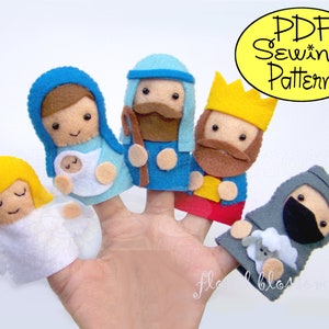 May include: A set of felt finger puppets depicting the Nativity scene. The puppets include Mary, Joseph, the baby Jesus, an angel, a shepherd, and one of the three wise men. The puppets are all wearing traditional clothing and have friendly faces.