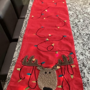 Pier 1 Table runner Red Christmas with reindeer. it lights up. 70" long x 12.5 inches wide