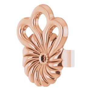 May include: Rose gold ear cuff with a swirl design and a decorative top. The top features a three-loop design.