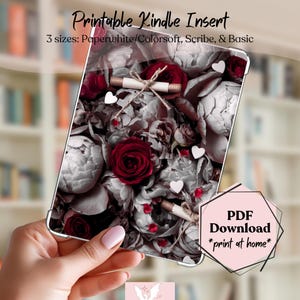 May include: A Kindle insert featuring a floral design with red roses, white hearts, and scroll accents. The text reads "Printable Kindle Insert" and "PDF Download *print at home*". The insert is available in three sizes: Paperwhite/Colorsoft, Scribe, & Basic.