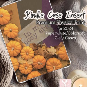 May include: A rectangular Kindle case insert featuring a fall-themed design with orange pumpkins and dried leaves. The text reads Kindle Case Insert Premium Physical Print for 2024 Paperwhite/Colorsoft Clear Cases and In my cozy era.