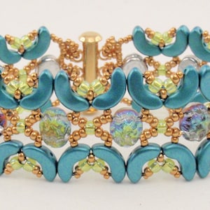 May include: A handcrafted bracelet featuring turquoise crescent-shaped beads, gold-colored seed beads, and iridescent glass beads. The bracelet has a gold-colored clasp and a delicate, intricate design. A beautiful piece of jewelry.