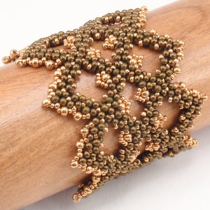 May include: A gold and brown beaded bracelet with a geometric design. The bracelet is made of small, round beads that are woven together in a intricate pattern.