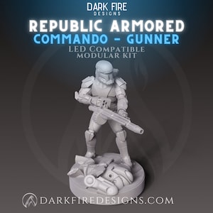 May include: A gray Republic Armored Commando Gunner figure, holding a large weapon, stands on a circular base with debris. The figure is part of a modular kit, as indicated by the text. The Dark Fire Designs logo is at the top and bottom.