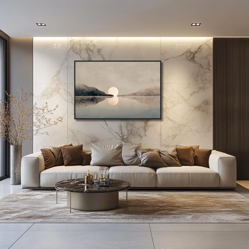 May include: A rectangular wall art print in a black frame featuring a landscape painting of a calm lake, dark mountains, and a glowing full moon centered on the horizon, with a soft reflection of the moon visible on the water surface.