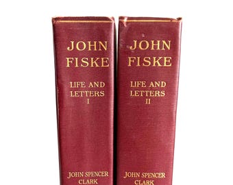 May include: Two vintage books, "Life and Letters I & II" by John Fiske, with burgundy covers and gold lettering. The books are by John Spencer Clark and published by Houghton Mifflin Co. The spines are visible, standing upright against a white background.