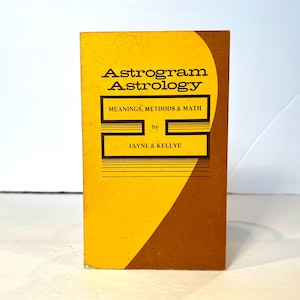May include: A yellow and brown book titled "Astrogram Astrology: Meanings, Methods & Math" by Jayne & Kellye.