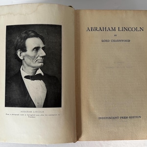 May include: A vintage book titled "Abraham Lincoln" by Lord Charnwood. The cover features a black and white photograph of Abraham Lincoln in a suit and bow tie. The book is part of the Independent Press Edition.