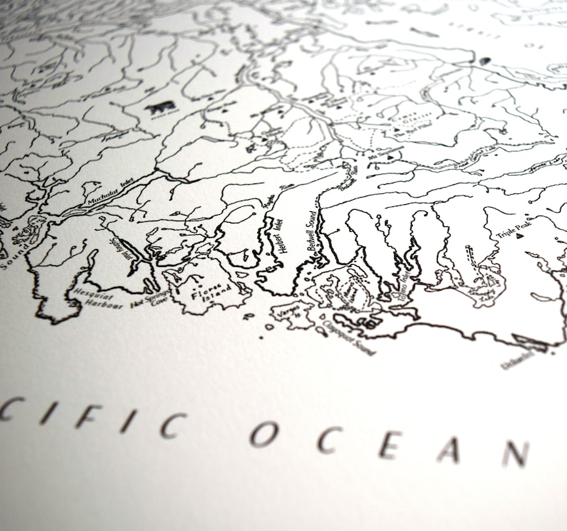May include: A monochrome map print showing detailed coastlines, rivers, and geographical features. The words "PACIFIC OCEAN" are printed in a serif font at the bottom. The map appears to be of a coastal region.