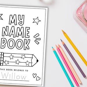 May include: A black and white colouring book titled "MY NAME BOOK" with a pencil illustration and the text "THIS BOOK BELONGS TO Willow". Colouring pencils in various colours are arranged on a white surface.