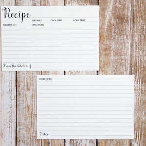 May include: Two blank recipe cards with lined sections for ingredients, directions, servings, cook time, cook temp, and notes. The cards are on a wood background.