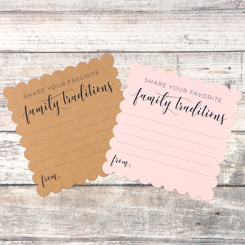 May include: Two cards with scalloped edges, one brown and one pink, with the text "SHARE YOUR FAVORITE family traditions" and a line for writing.  The cards are on a woodgrain background.