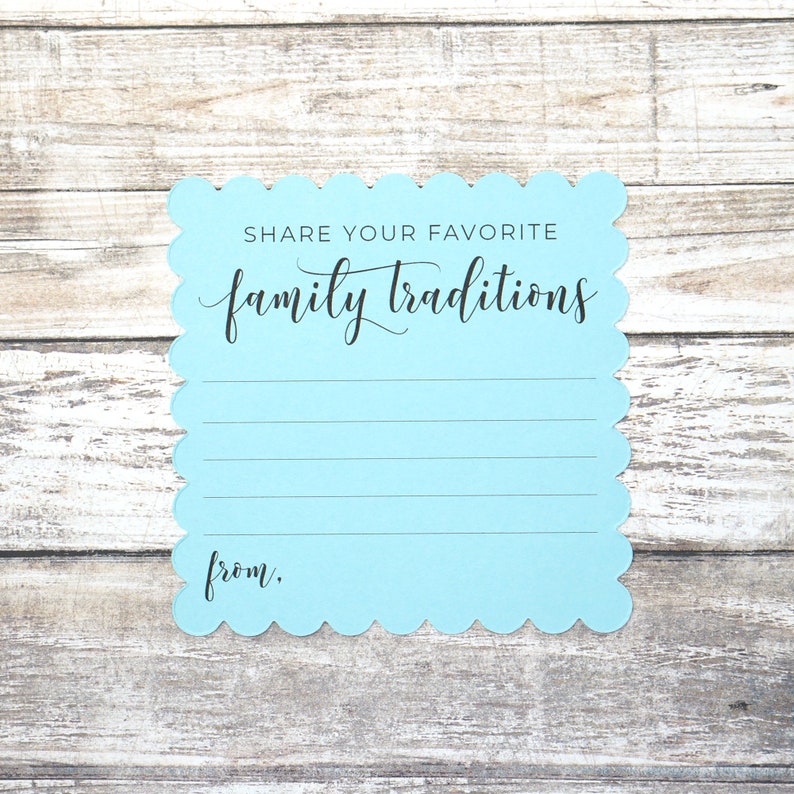 May include: A light blue card with scalloped edges, inviting guests to share their favorite family traditions. The card has the text "Share your favorite family traditions" and "from:" printed in black.