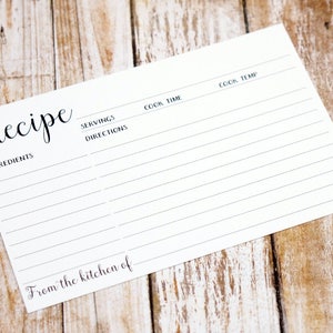 May include: A blank white recipe card with the word "Recipe" at the top and lines for writing down ingredients, directions, servings, cook time, and cook temperature. The card also has the text "From the kitchen of" at the bottom.