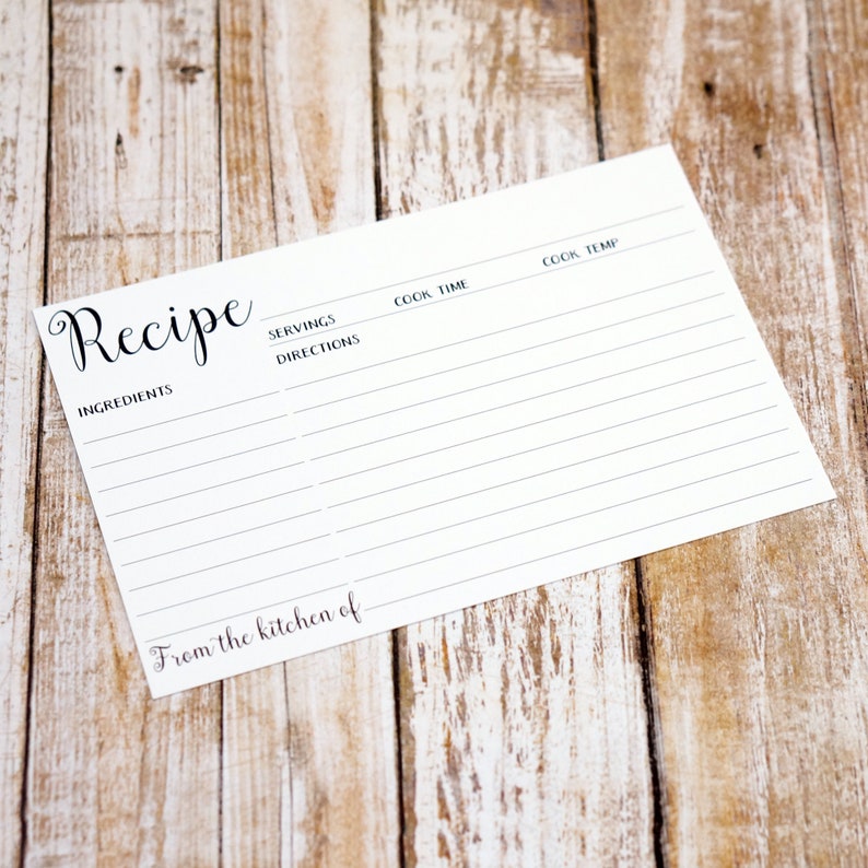 May include: A blank white recipe card with the word "Recipe" in black cursive at the top. The card has sections for ingredients, servings, directions, cook time, and cook temperature. The bottom of the card says "From the kitchen of".