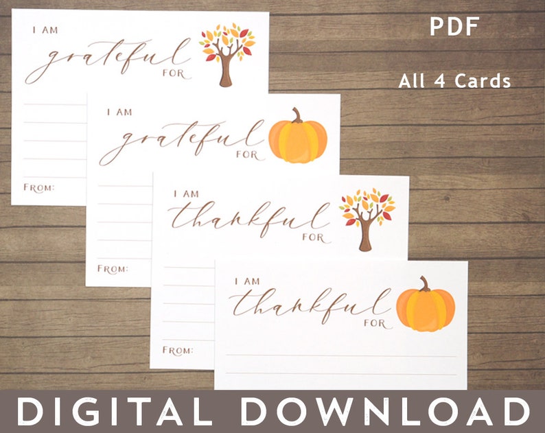 May include: Four printable cards with a fall theme. The cards have a white background with brown lines and the text "I am grateful for" and "I am thankful for". Two cards feature a pumpkin and two cards feature a tree with orange, red, and yellow leaves.